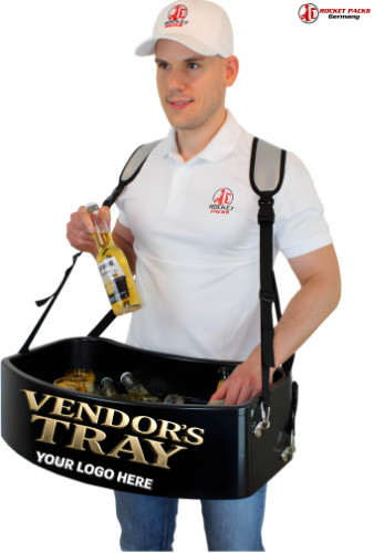 Brand Vendor´s Vending Tray (also known as sampling stations, stadium trays, Usherette trays, falcon trays, sampling trays, 2020 Dezember. Usherette trays, roaming trays or mobile sales trays) are the uncomplicated and versatile way to realize your product appearance as mobile as in the twinkling of an eye. Simply buckle onto the tray, fill it with the product and off you go!